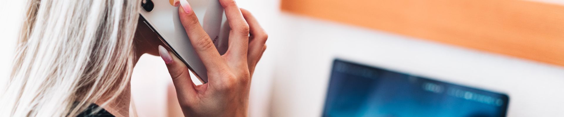 Lady on the telephone and using her laptop